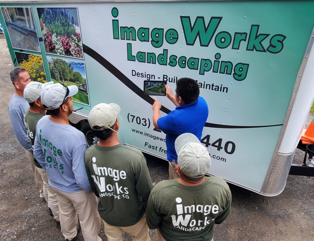 Landscape designer measuring and planning a garden.
