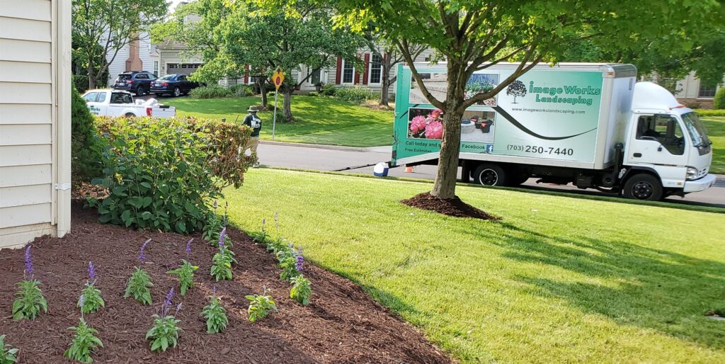 Landscaper mowing a lawn