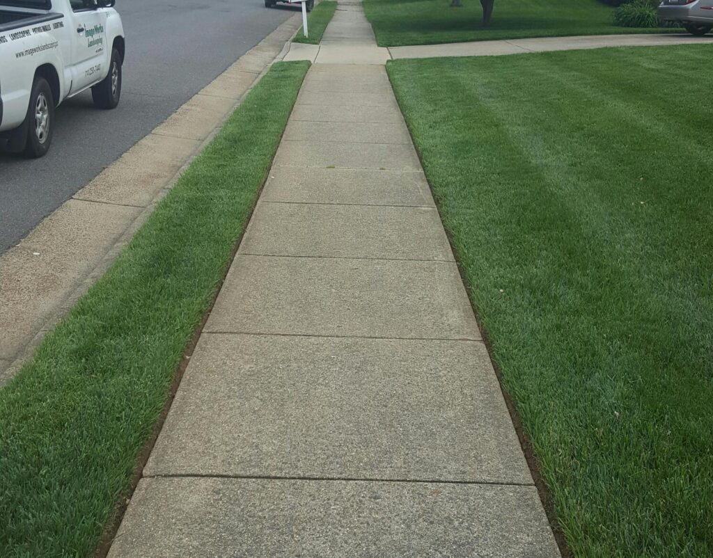 Image Works Landscaping- Lawn care tools and equipment on a neatly cut grass lawn