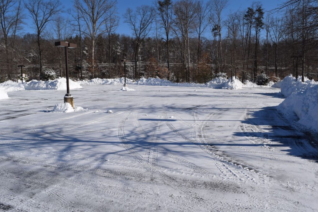 Snow plow clearing a residential driveway